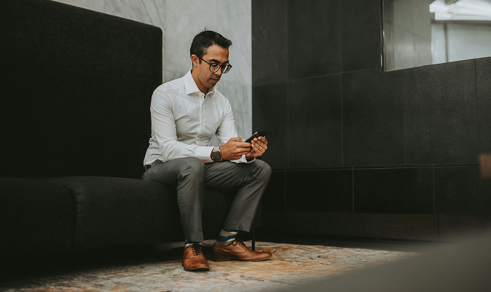 Confident solo founder researching non-equity funding options at home, surrounded by notebooks, legal documents, and a laptop displaying grant and business credit tools.