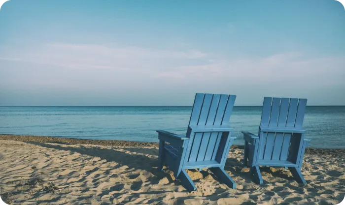 Two Wooden Chairs On Beach