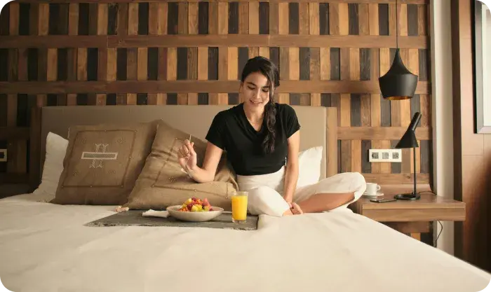 Woman Enjoying Breakfast In Cozy Hotel Room 1767032167