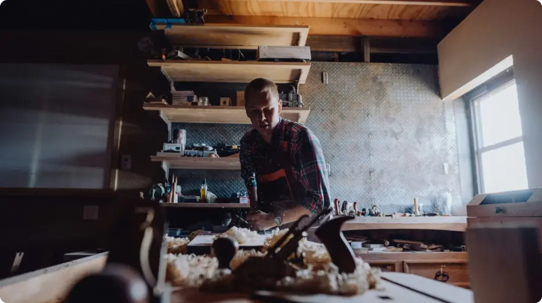Carpenter At Work In Workshop
