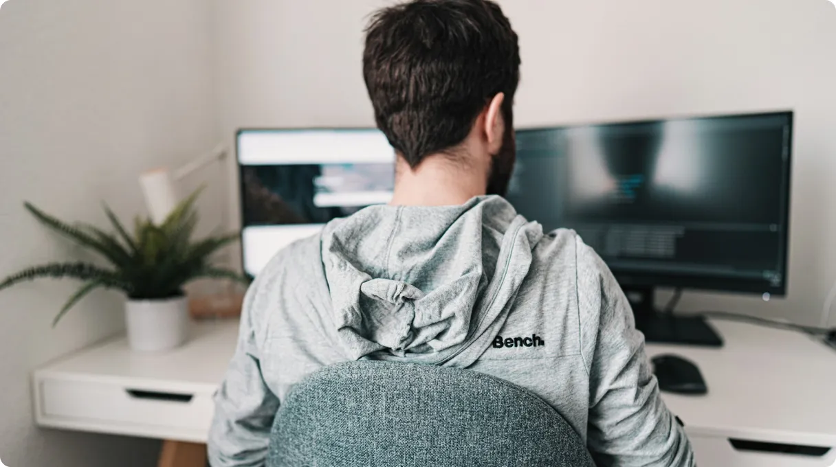 Man In Gray Hoodie Sitting On Chair